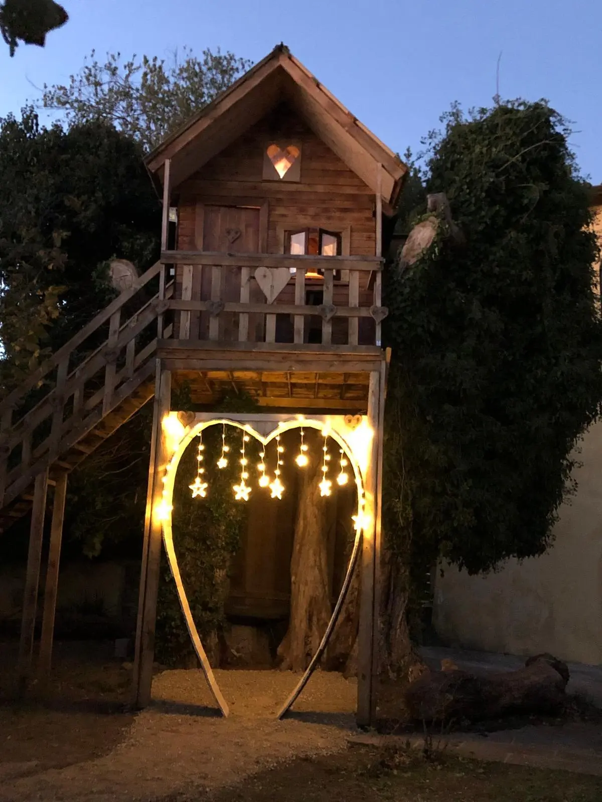 The tree house lit up in the evening