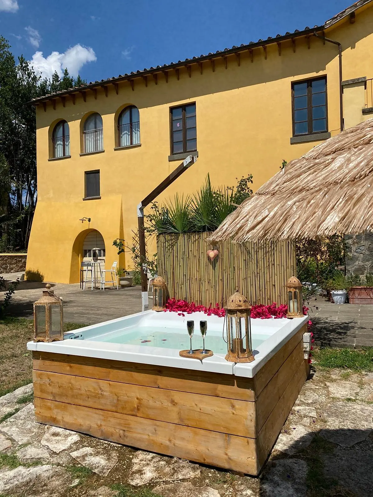 The outdoor Jacuzzi with its straw parasol