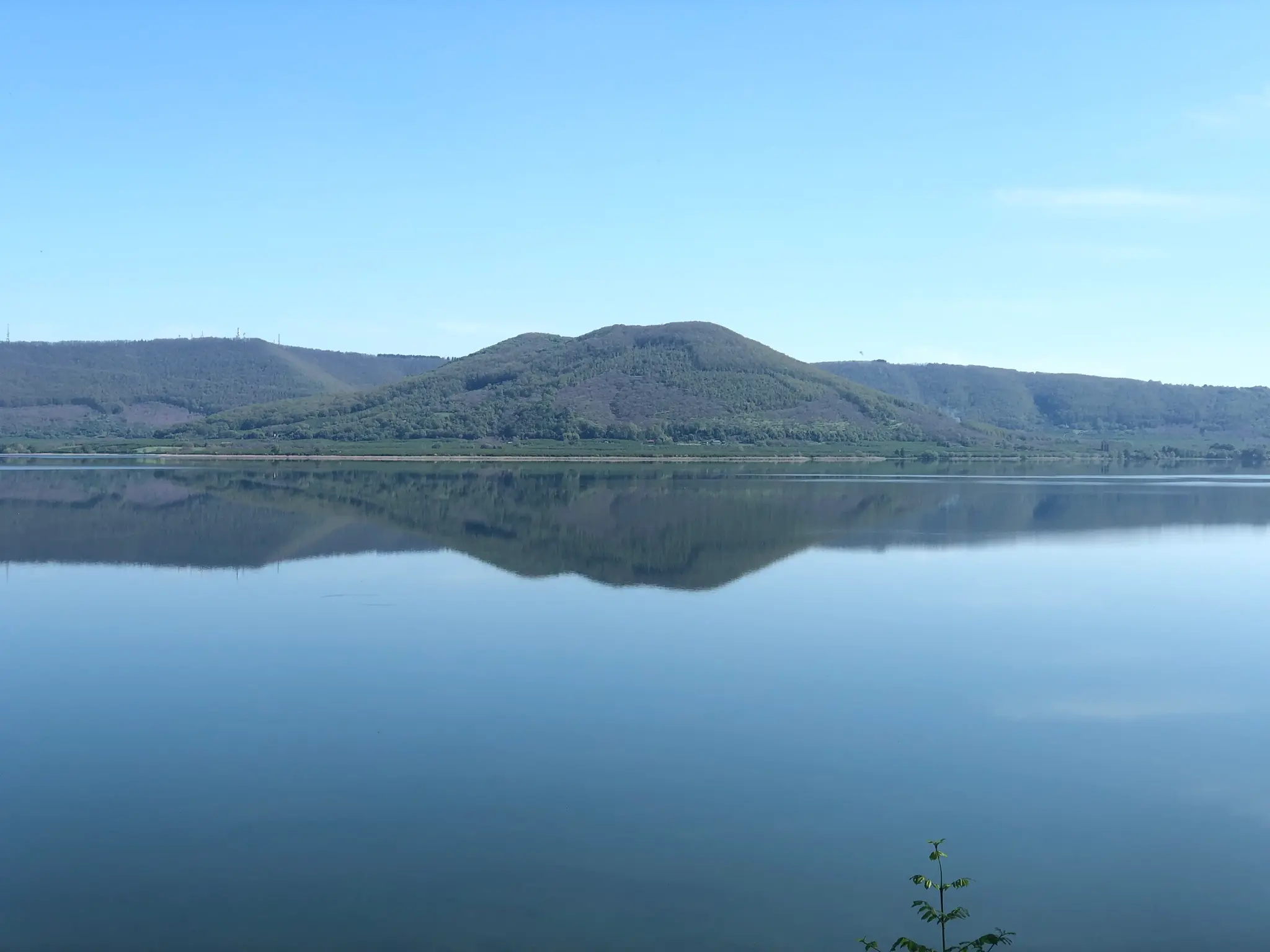 Lake Vico on a still day, with Monte Venere reflected in the water