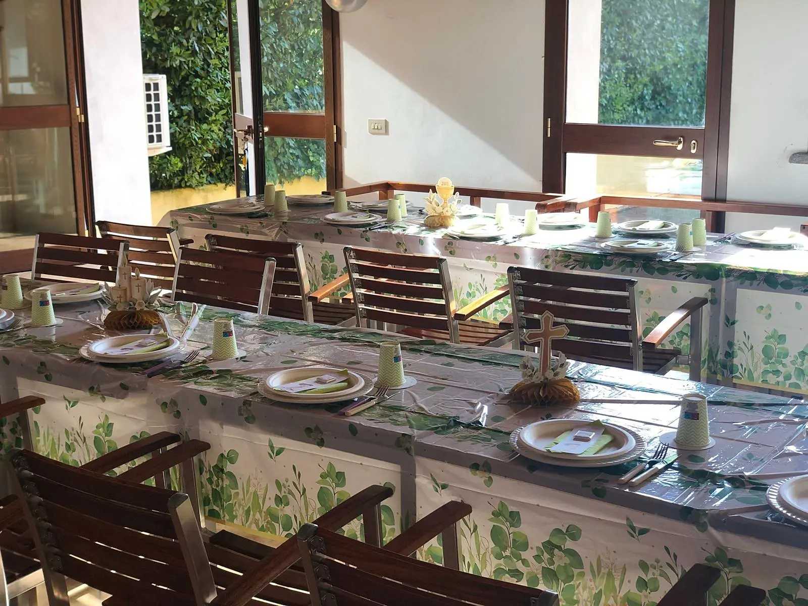The event room with the table laid and windows onto the garden